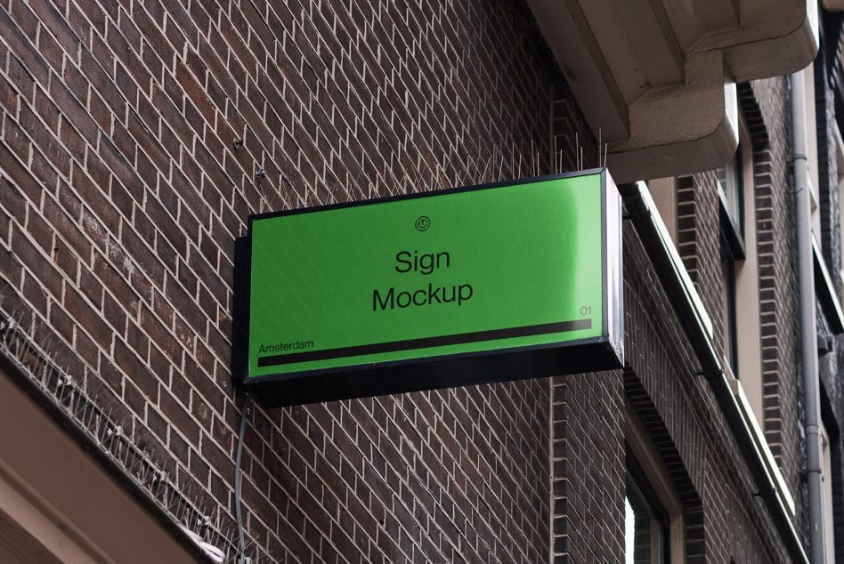 Vibrant green horizontal sign mounted on textured brick building exterior